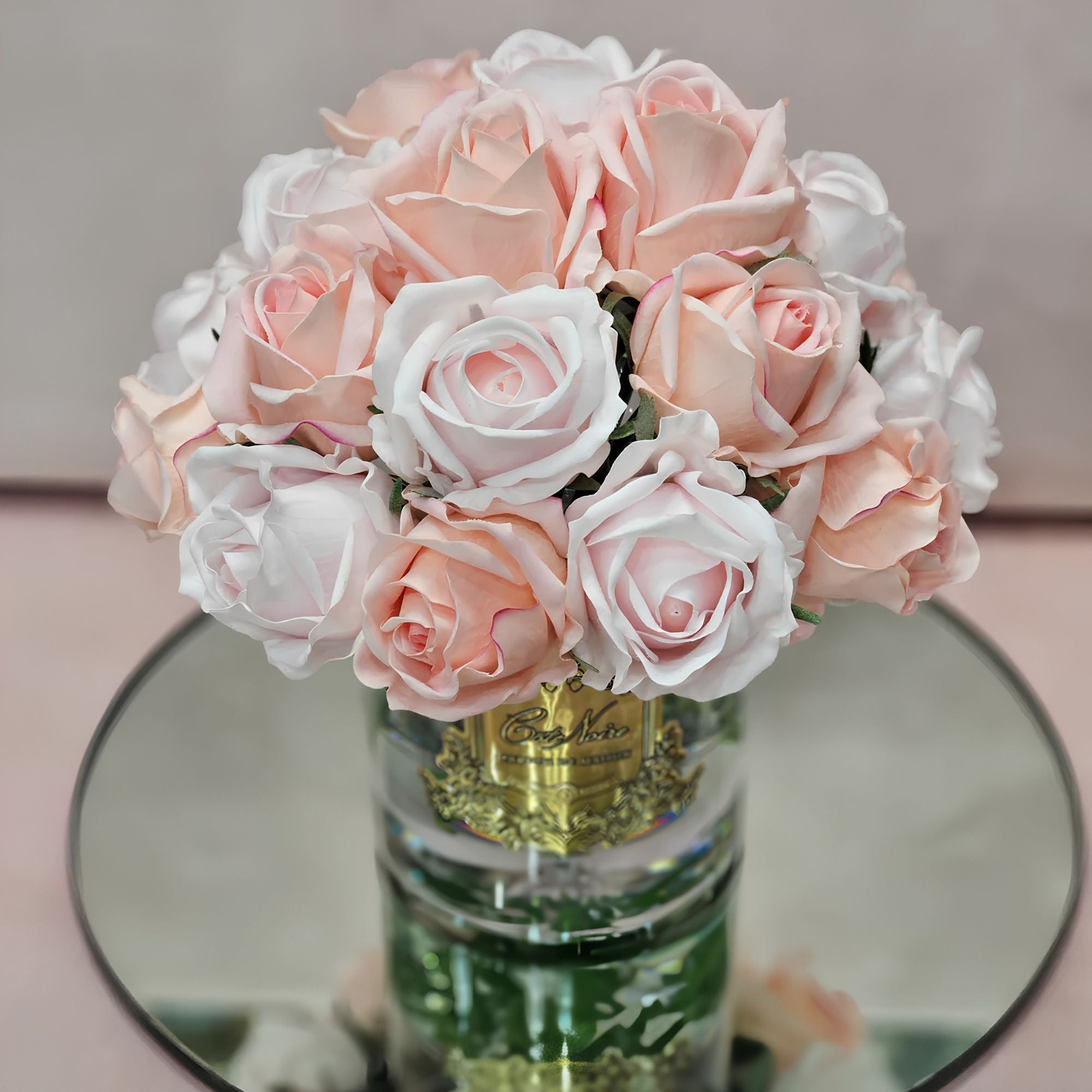 Close-up of Côte Noire Grand Bouquet mixed pink rose buds in clear gel with gold badge detail