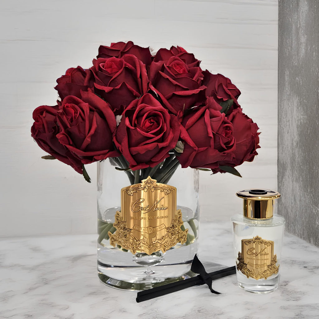 Close-up of Côte Noire Luxury Grand Rose Bud Bouquet red rose buds in clear gel with gold badge detail