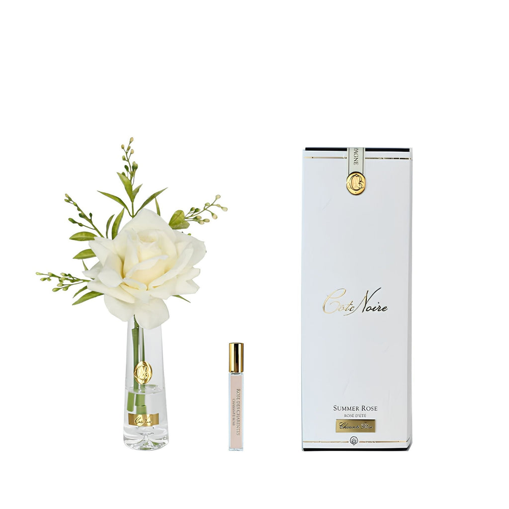 Côte Noire Champagne Summer Rose in clear vase with gold badge