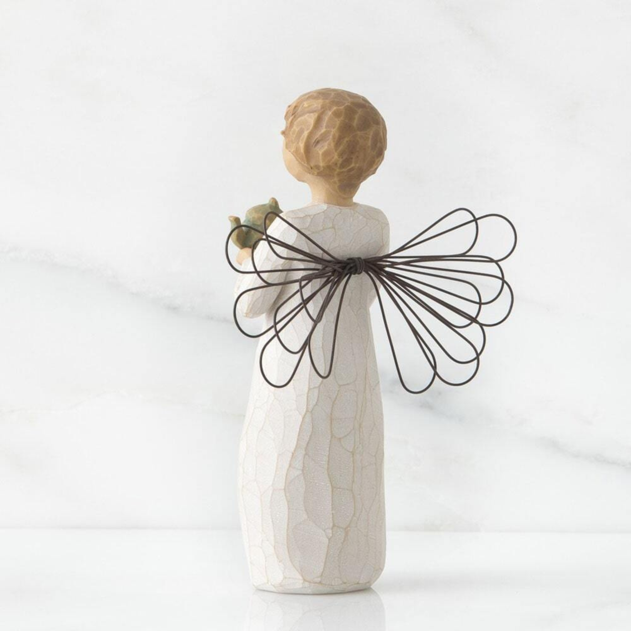 Side view of Willow Tree Angel of the Kitchen figurine showing sculpted form